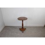 A Victorian mahogany pedestal wine table, the moulded circular top above the turned column and