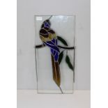 A leaded and stained glass panel depicting a perched macaw 54cm x 26cm