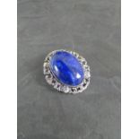A white metal and oval Lapis Lazuli cabochon brooch, with pendant suspension loop to reverse 3.5cm