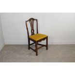 A George III oak dining chair, with yoke-form top-rail above a central pierced splat and shaped