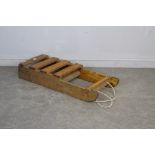 A vintage home-made pine sledge with iron runners 108cm