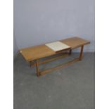 A 1970's Remploy teak extended coffee table with central additional melamine 'leaf' 45cm x 151cm (