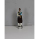 An unusual figural painted decanter bottle, depicting a musician, painted in polychrome, contents