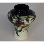 A Moorcroft pottery vase tube-lined and painted in the Anna Lily pattern, painted and impressed