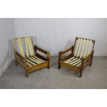 A mid-late 20th century teak three-piece suite, comprising two armchairs and settee, all reclining