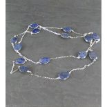 A 925 grade white metal and Lapis Lazuli necklace, with fine chain and facet-cut pear shaped links