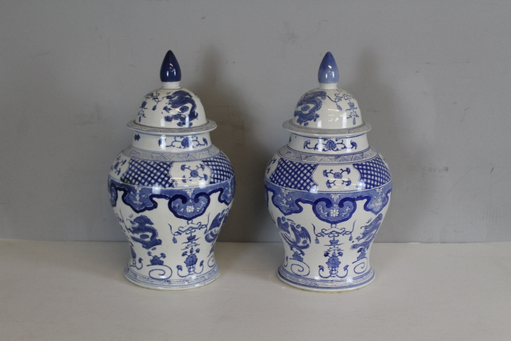 Pair of modern blue and white pottery baluster shaped vases and covers of Chinese design 86cm