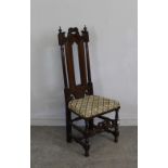 A carved oak hall chair with scrolled crest-rail, padded seat, block and turned stretchers 120cm