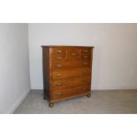 A mahogany 'Scotch' chest in the Victorian style with embossed brass back plates and bale handles,