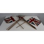 A group of nine union flags, British Made on slender canes 52cm x 33cm