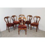 A set of six Victorian James Reilly (Manchester) mahogany balloon-back dining chairs with central