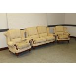 A modern mahogany show-frame three piece suite in cream patterned upholstery