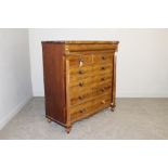 A Victorian figured mahogany chest of drawers, with inverted break-front top over cushion moulded