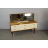 A 1980's laminate dressing table 106cm x 135cm x 42.5cm