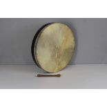 An Irish Bodhran and tipper 45cm diameter & 20cm long