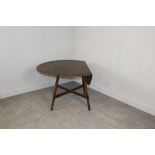 An Ercol Dark Elm circular drop-leaf table, with X-form stretcher 70cm x 124cm extended x 113cm