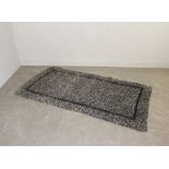 A vintage proddy or hooky rug with border 200cm x 106cm
