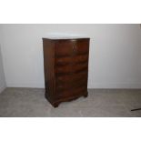 An early 20th century figured walnut tallboy chest, serpentine fronted with two cupboard doors