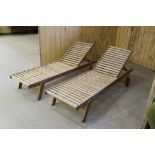 A pair of teak reclining sun loungers 33cm x 196cm used/weathered.