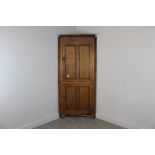 A George III oak and mahogany banded double corner cupboard, with moulded cornice and broad mahogany