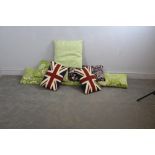 A group of eight modern patterned cushions, green repeating pattern, green floral, purple floral and