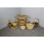 A circular woven-wicker log basket 47cm x 48cm and eeight woven-wicker florists baskets of varying