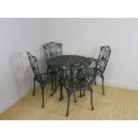 A cast and green-painted aluminium garden table and four chairs, in the Victorian style 68cm x