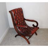 A deep-buttoned and studded oxblood leather 'Chesterfield' type slipper chair, with partiality