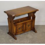 A Chapman's Siesta House oak magazine table, of 17th century design with lozenge carved panels