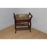 A late Victorian mahogany piano stool, the cushioned hinged seat between scrolled out and spindle