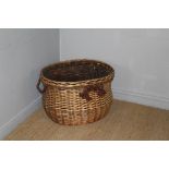 A large modern woven-wicker log basket, with applied rope handles 46cm x 69cm x 58cm minor damage