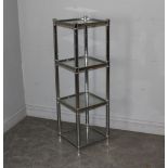 A chromed effect and glass four tier bathroom stand 113cm x 35cm some marks and scratches.