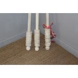 Three white-painted curtain poles, in the Victorian style, each with numerous curtain rings, two