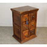 A modern imported wood six drawer chest, with fielded short drawers with ring handles and double