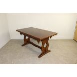 A dark stained elm refectory draw-leaf table with trestle type supports, in the Priory style 77cm