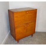 A 1970's teak cocktail/record cabinet, with fall-front enclosing the mirrored drinks section over