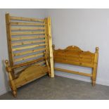 A modern pine double bed, with headboard, footboard, slatted base with additional support, generally
