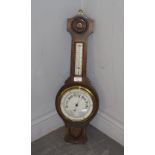 A mid 20th century oak wheel or banjo barometer, with thermometer scale and silvered dial, by R