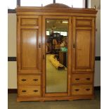 A Victorian ash mirror-door wardrobe, the moulded cornice with arched and carved surmount over the