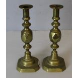 A pair of brass 'King Of Diamonds' brass ejector candlesticks 31.5cm, one missing the ejector disc.