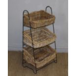 A metal and woven-wicker three tier vegetable rack 92cm x 47cm x 31cm minor damage to wicker work,