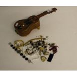 A Spanish olive wood guitar shaped jewellery box and a selection of costume jewellery, box cover