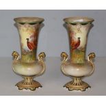 A pair of Crown Devon Flared urn-form vases, hand-painted with pheasants in a woodland setting,