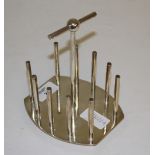 A silver plated toast rack, after a design by Sir Christopher Dresser, with tubular upright