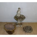 A cast composite stone bird bath, with figural flute player surmount over the scallop shell form top