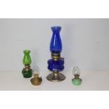 A vintage chromed and blue glass oil lamp, and three smaller similar CHIMNEYS DAMAGED IN VIEWING!