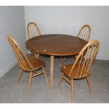 An Ercol light elm drop-leaf dining table and four tall hoop-back chairs 72cm x 114cm x 125cm & 98cm