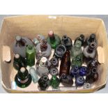 A collection of Victorian and later coloured and clear glass bottles