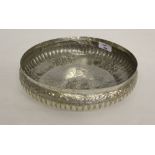 An Indian white metal bowl, with embossed decoration,