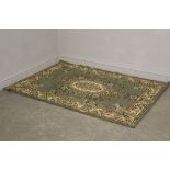 A Green and cream machine-made rug of Persian design 168cm x 120cm in good condition.